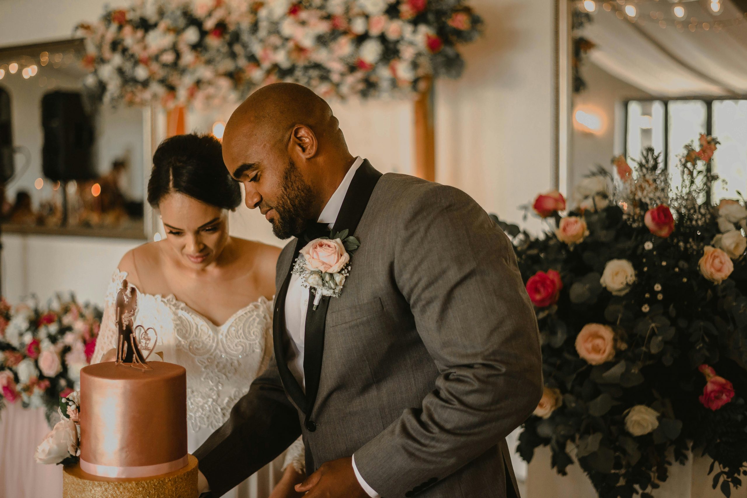 bride and groom slicing their wedding cake together
